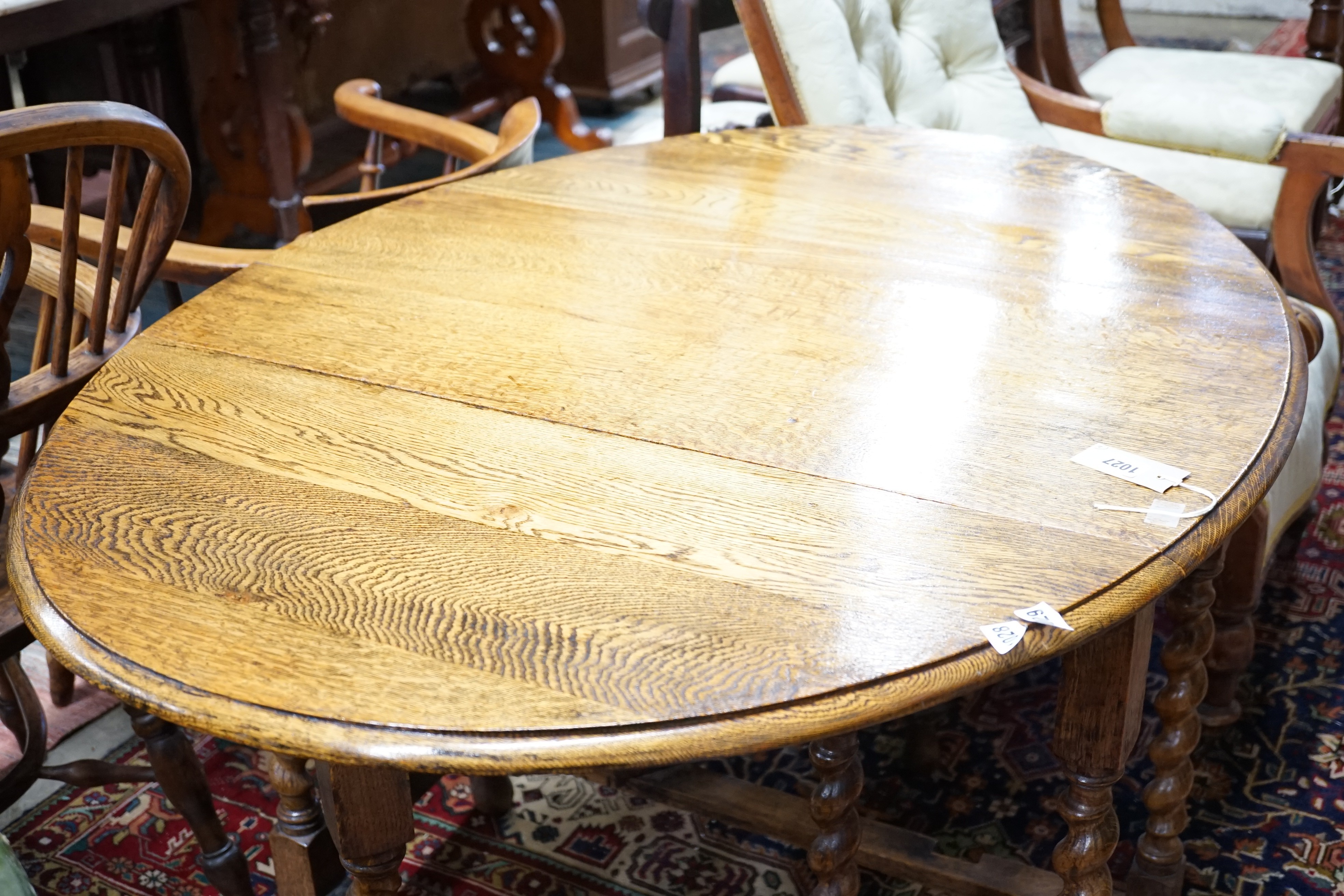 A 1920's oak gateleg table opens to 117 x 90cm and an Edwardian carved oak folding occasional table, width 45cm